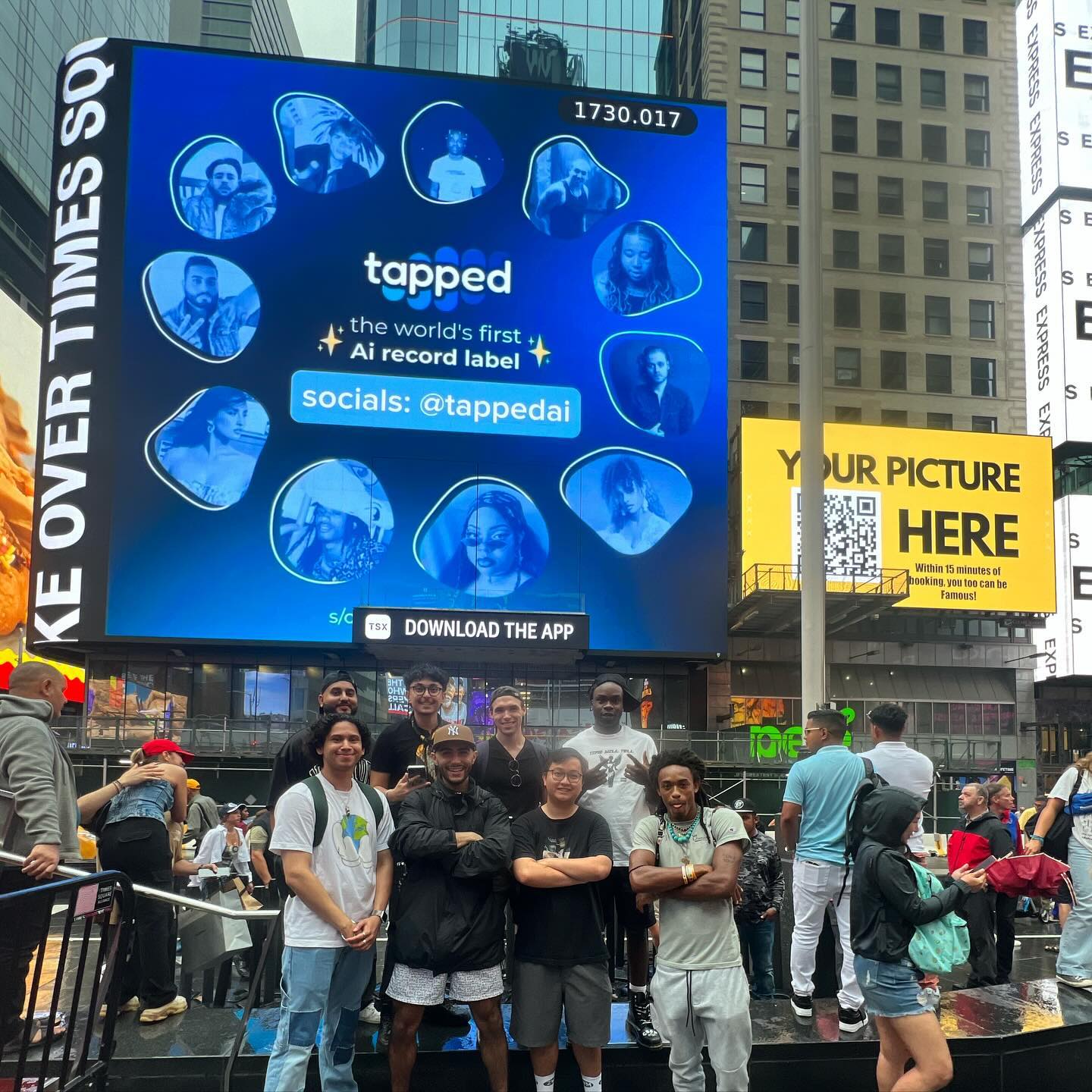 TappedAI team smiling together in front of their Times Square billboard